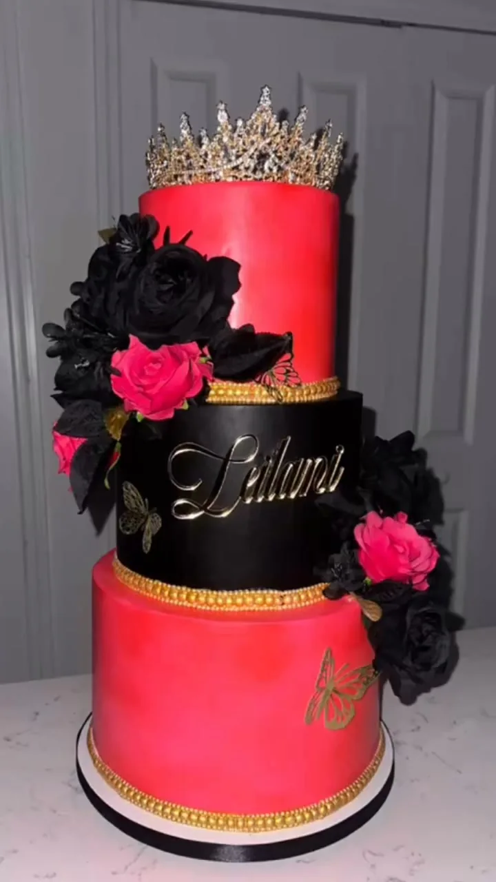 Tall red and black tiered cake with roses